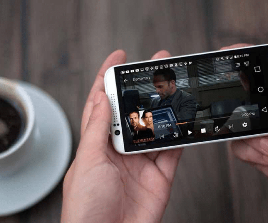 Photo of a smartphone that's holded by a person's hands, watching a movie on a streaming platform, provided by MwareTV